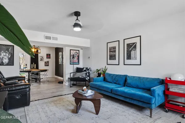 a living room with furniture ceiling fan and a rug