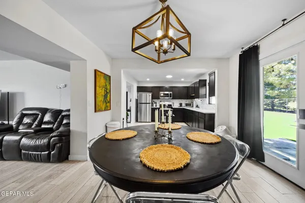 a dining room with furniture a window and wooden floor