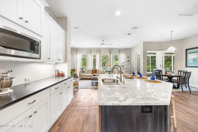 a view of hallway with livingroom and furniture