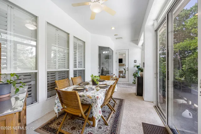 an aerial view of residential houses with outdoor space and swimming pool