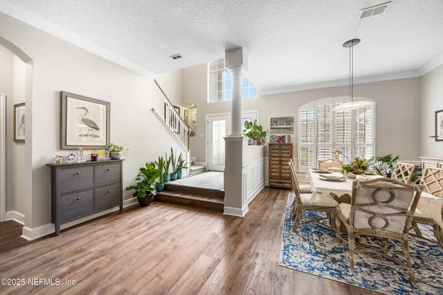 a living room with furniture a wooden floor and a large window