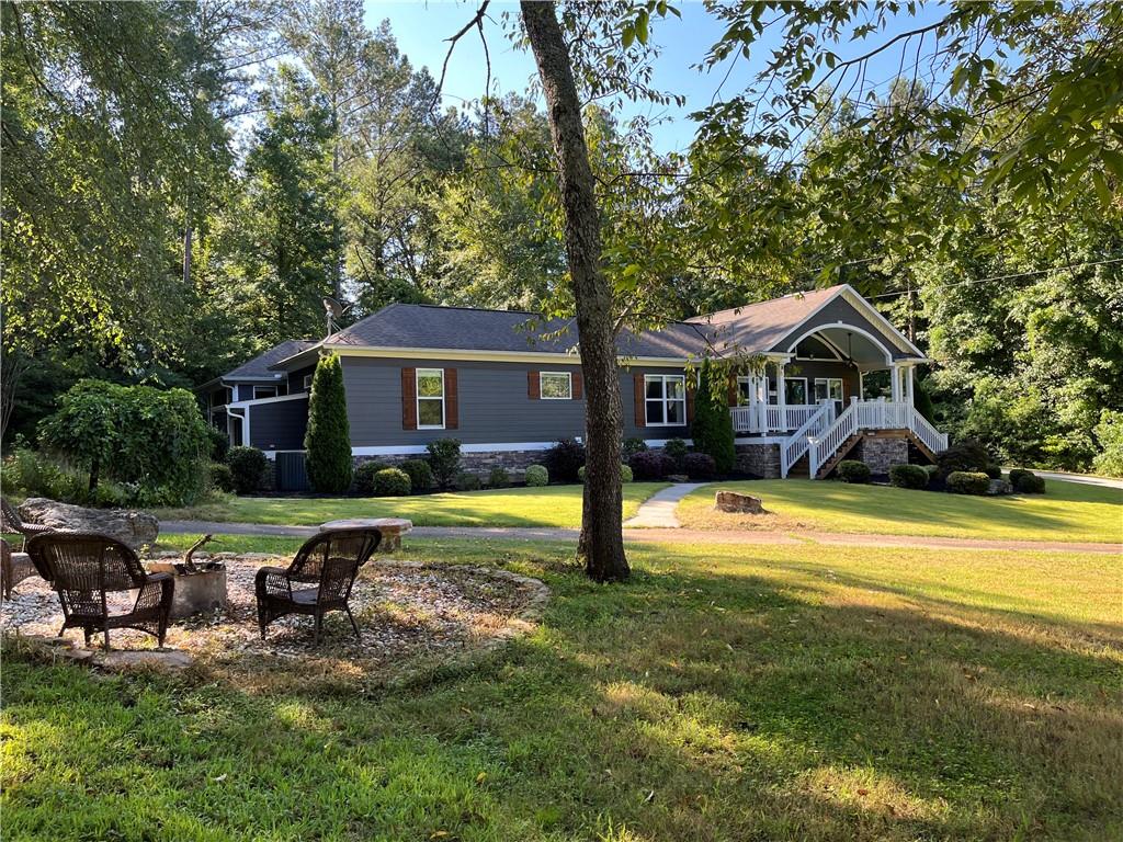 1122 Lewis Sailors Road Jefferson, GA 30549 - Photo 1 of 1 a view of a house with pool and chairs