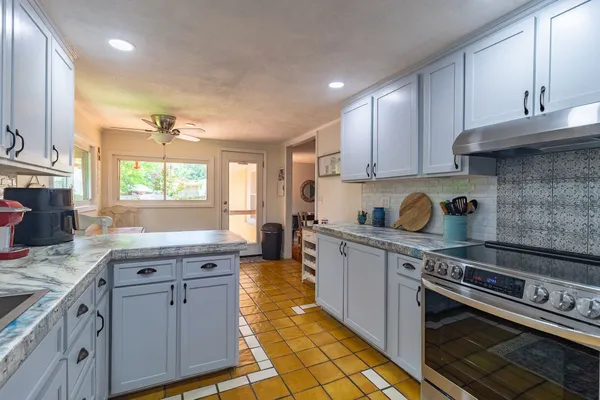 a kitchen with a table chairs and a refrigerator