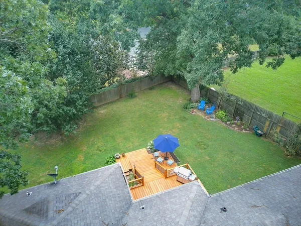 a view of a chair and table in backyard of the house