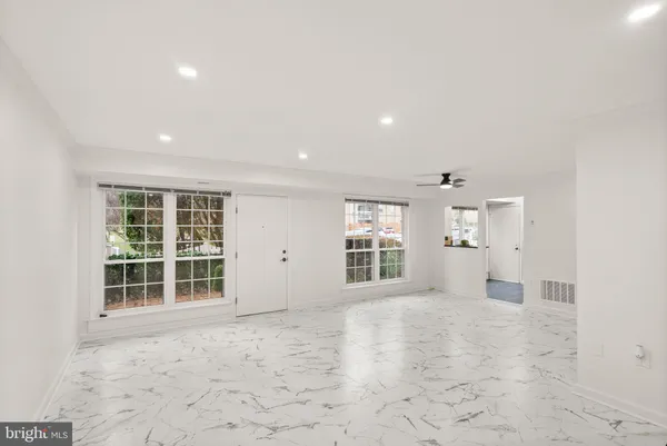 an empty room with windows and closet