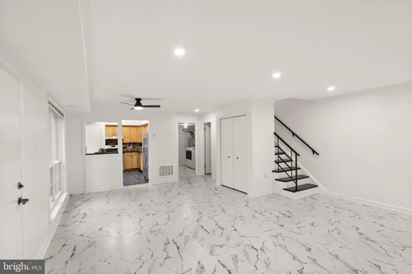a kitchen with stainless steel appliances granite countertop a stove and a refrigerator