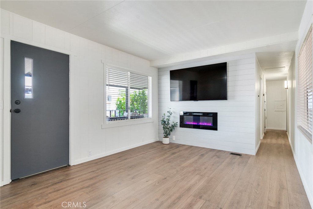 975 California Street, Unit 72 Calimesa, CA 92320 - Photo 8 of 23 a room with a flat screen tv a fireplace and a window