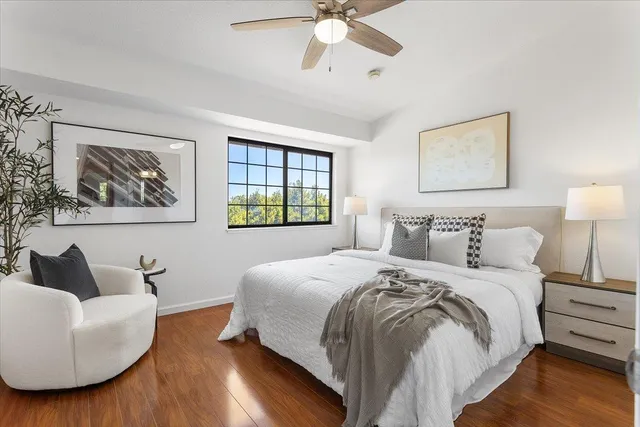 a bedroom with a bed and wooden floor