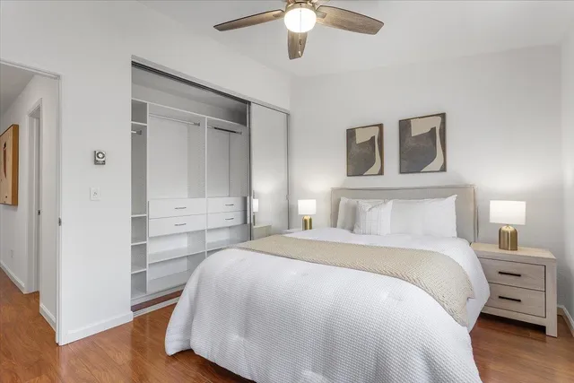 a spacious bedroom with a bed and a chandelier