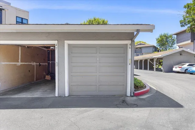 a view of small house with a garage