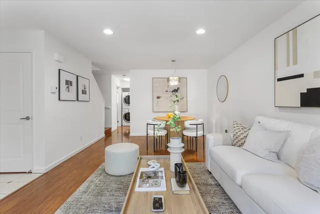 a living room with furniture and wooden floor