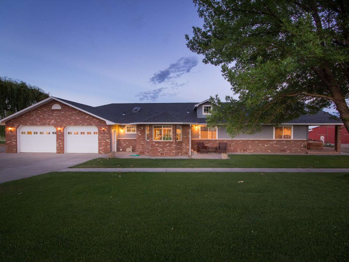 1640 12 Road Loma, CO 81524 - Photo 1 of 36 a front view of a house with a garden and yard