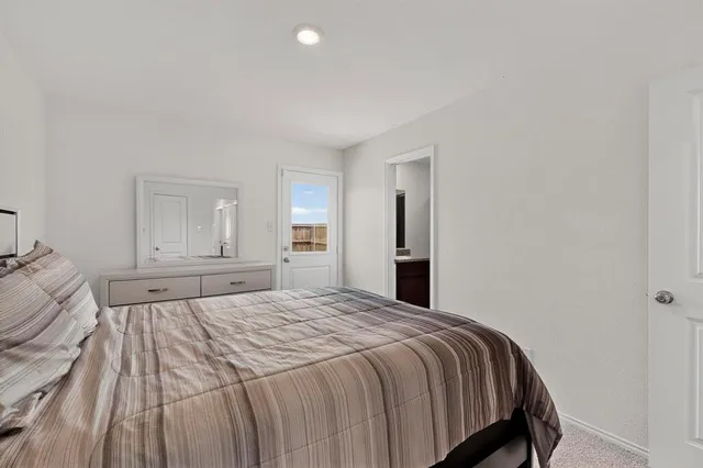 a bedroom with a bed and window