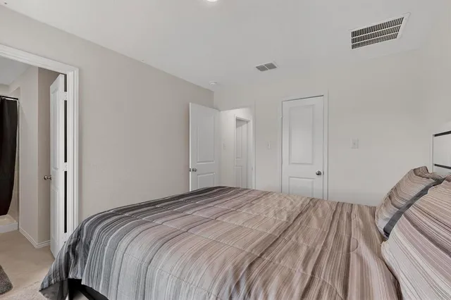 a bedroom with a bed and closet