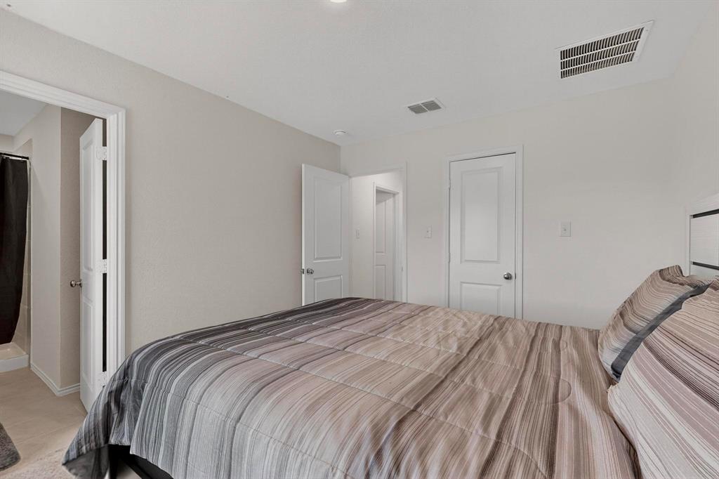 154 Herman Lane Princeton, TX 75407 - Photo 15 of 37 a bedroom with a bed and a hallway