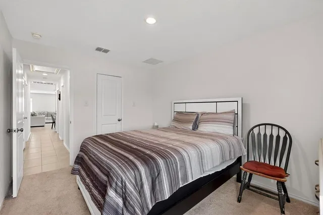 a bedroom with a bed and a hallway