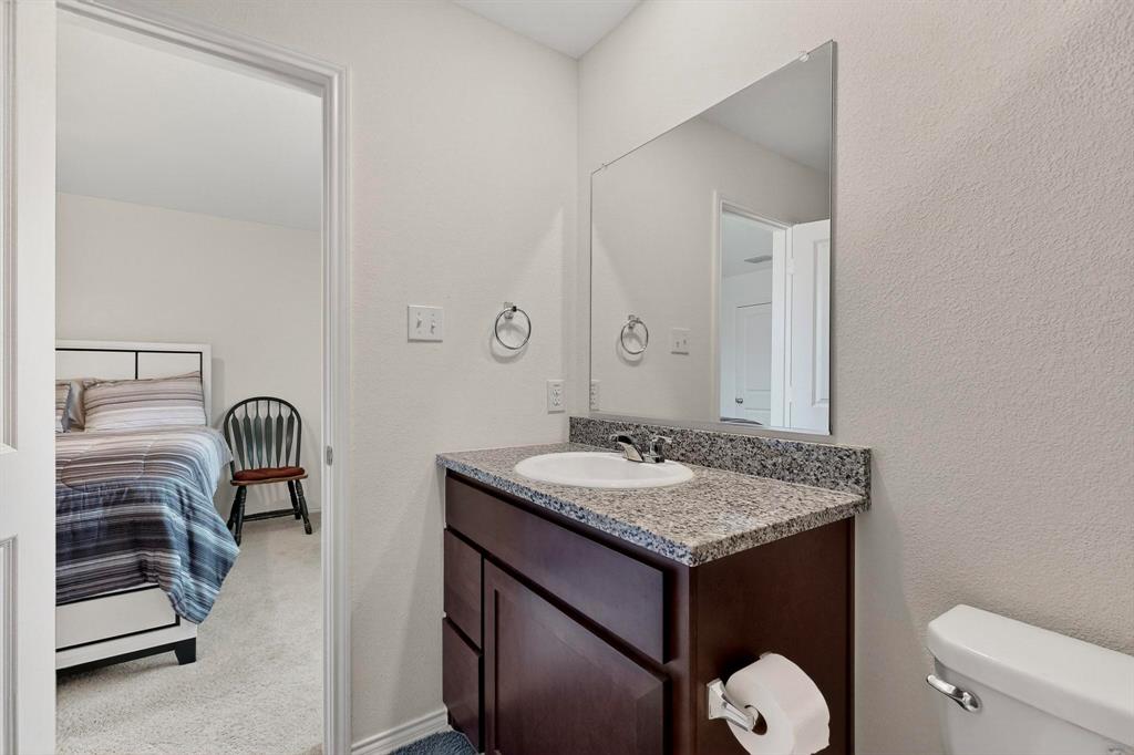 154 Herman Lane Princeton, TX 75407 - Photo 17 of 37 a bathroom with a granite countertop sink a toilet and mirror