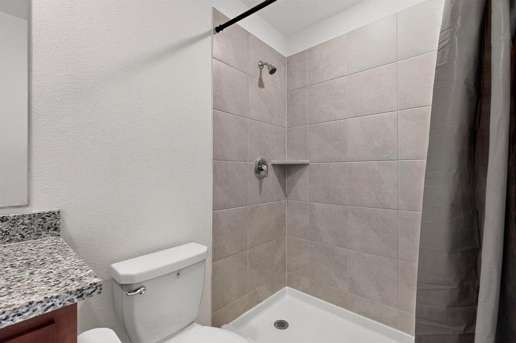 154 Herman Lane Princeton, TX 75407 - Photo 19 of 37 a bathroom with a shower and toilet