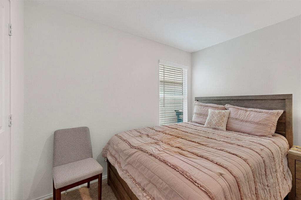 154 Herman Lane Princeton, TX 75407 - Photo 21 of 37 a bedroom with a bed chair and a window
