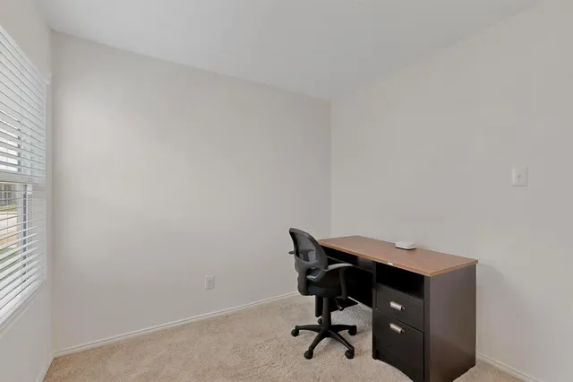 a view of a livingroom with chairs and a window in a room