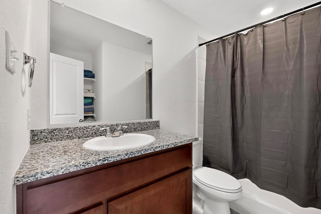 154 Herman Lane Princeton, TX 75407 - Photo 25 of 37 a bathroom with a granite countertop sink and a mirror