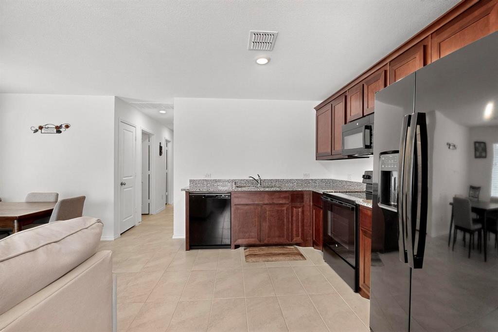 154 Herman Lane Princeton, TX 75407 - Photo 37 of 37 a large kitchen with cabinets and stainless steel appliances