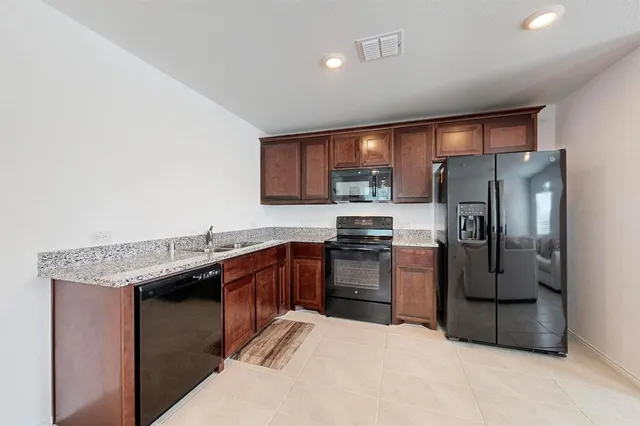 a large kitchen with cabinets and stainless steel appliances