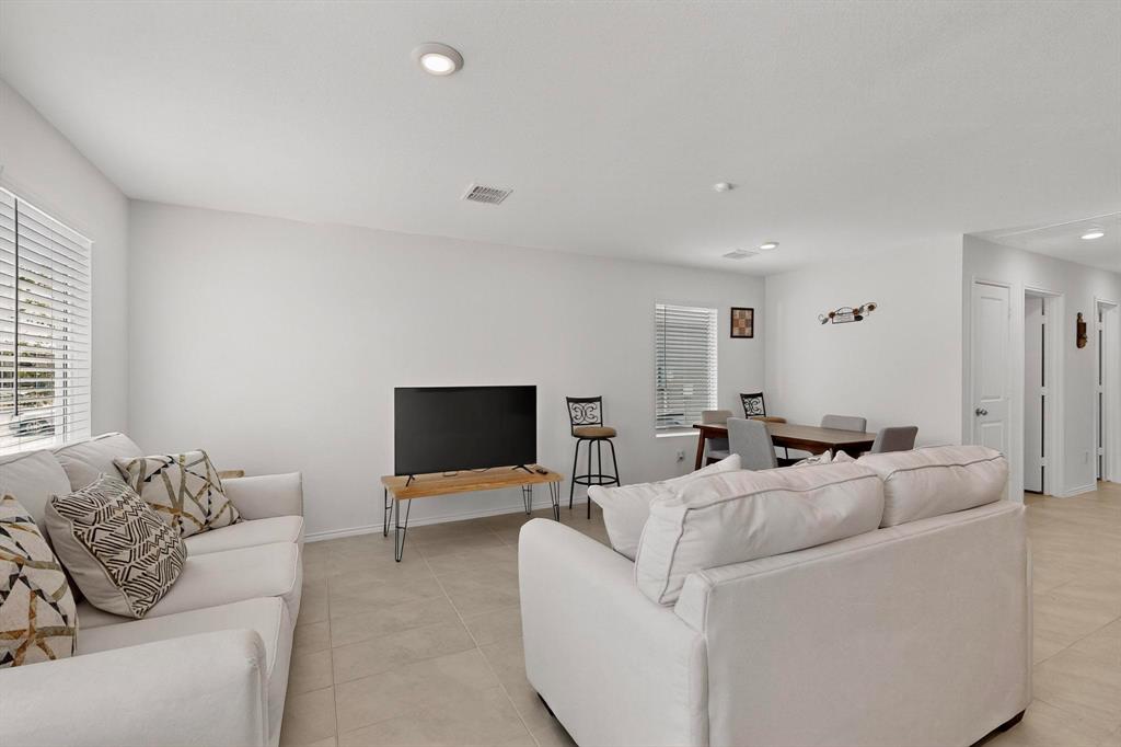 154 Herman Lane Princeton, TX 75407 - Photo 9 of 37 a living room with furniture and a flat screen tv