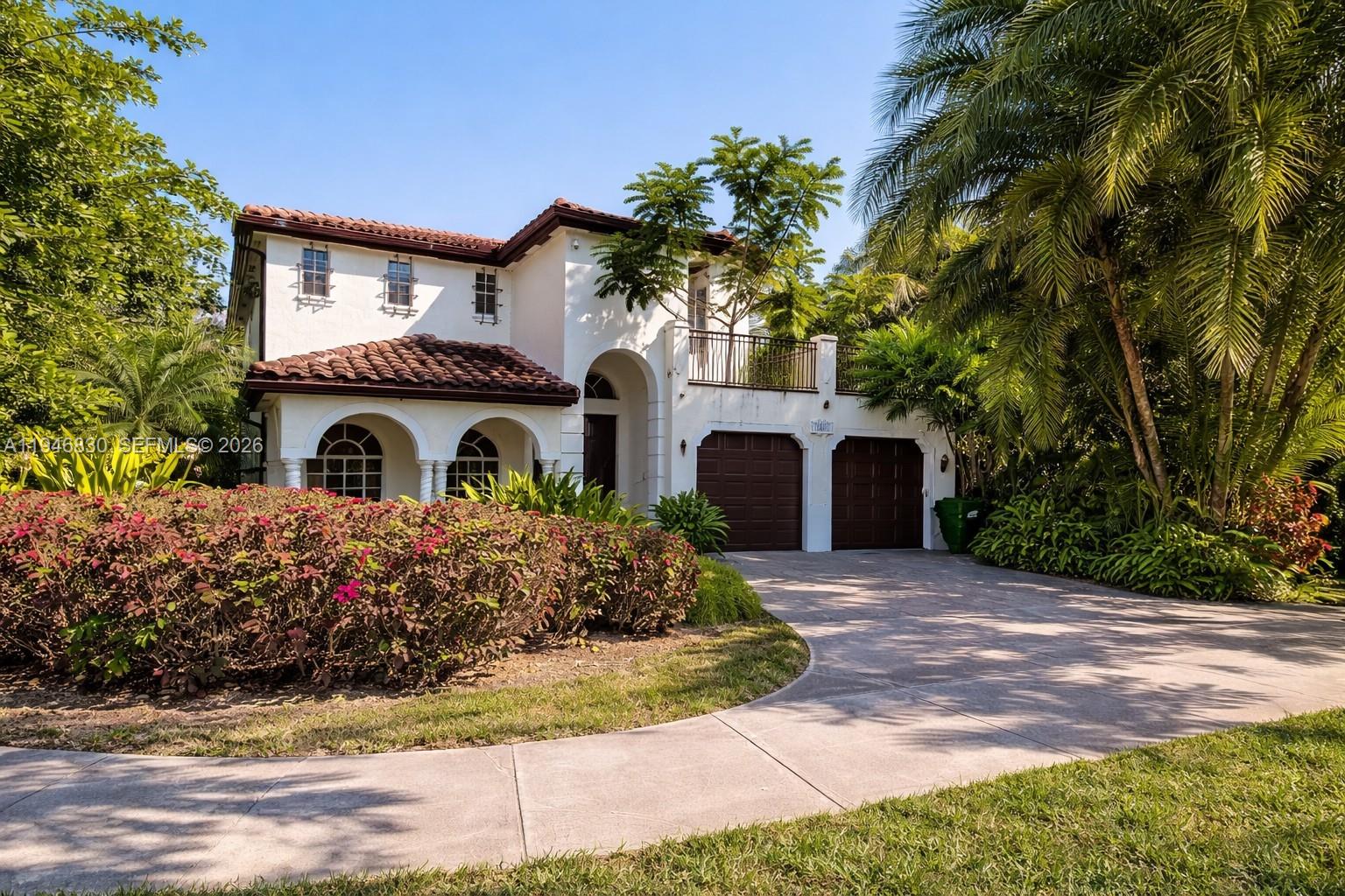 6601 Southwest 166th Court Miami, FL 33193 - Photo 1 of 28 a front view of house with yard and trees around