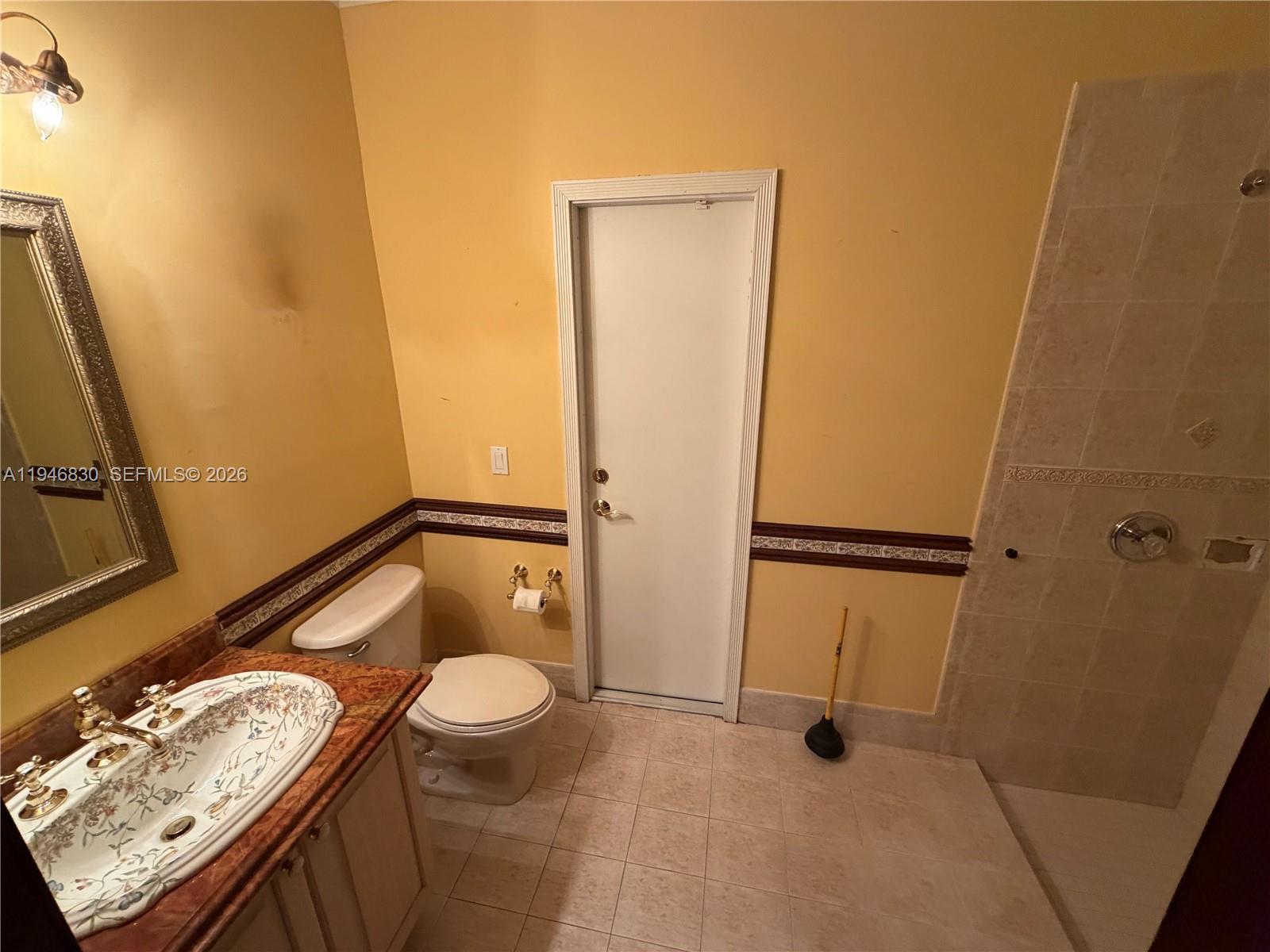 6601 Southwest 166th Court Miami, FL 33193 - Photo 14 of 28 a bathroom with a granite countertop sink toilet and shower
