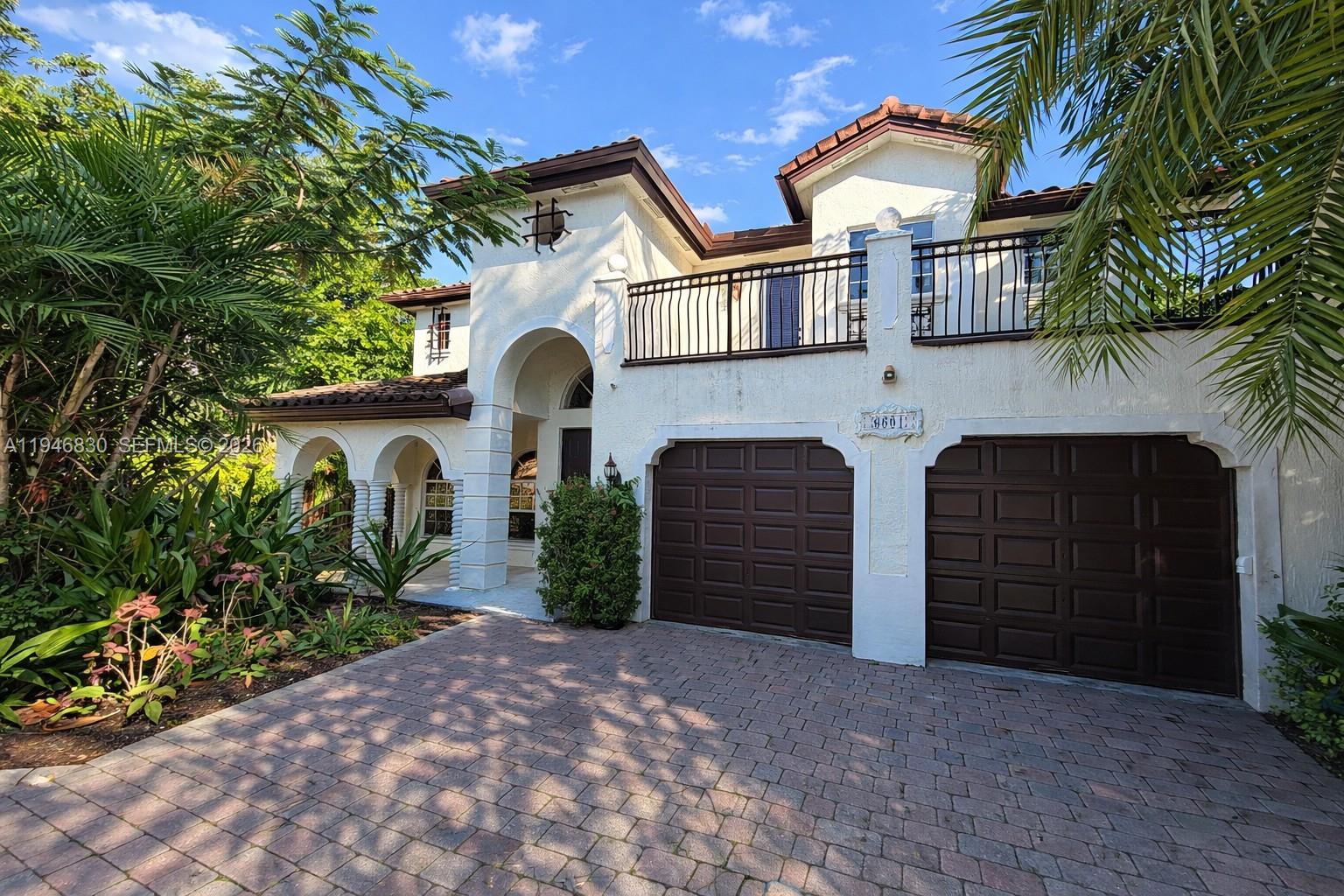 6601 Southwest 166th Court Miami, FL 33193 - Photo 2 of 28 a front view of a house with a yard
