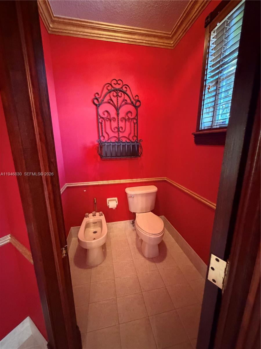 6601 Southwest 166th Court Miami, FL 33193 - Photo 23 of 28 a bathroom with a toilet and a sink