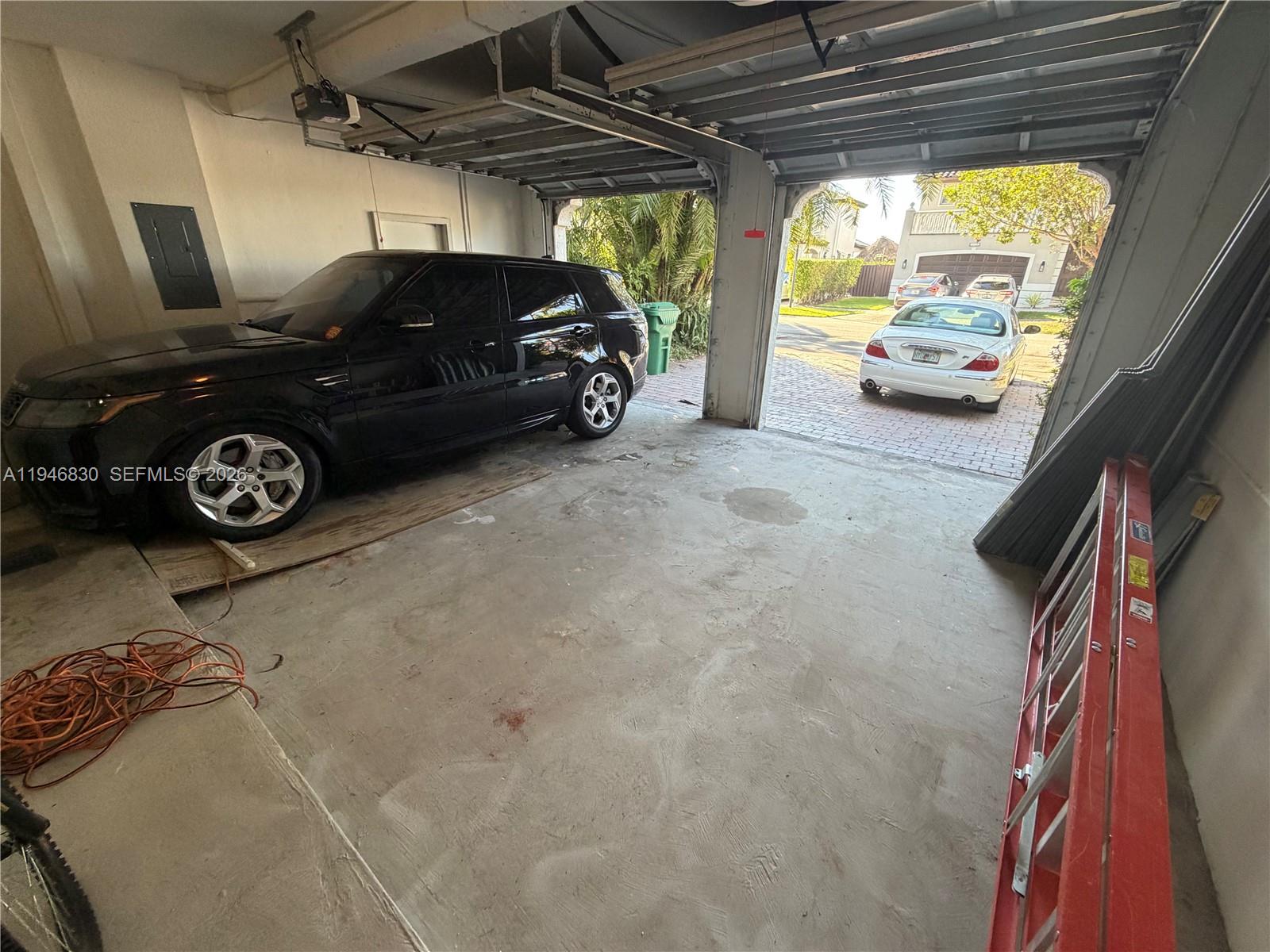 6601 Southwest 166th Court Miami, FL 33193 - Photo 27 of 28 a car parked in a garage
