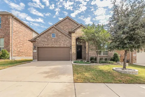 a front view of a house with a yard garage and outdoor seating