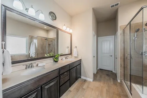 a bathroom with a double vanity sink and mirror