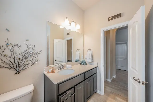 a bathroom with a sink vanity granite and a mirror