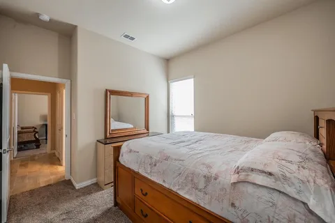a bedroom with a bed and a dresser