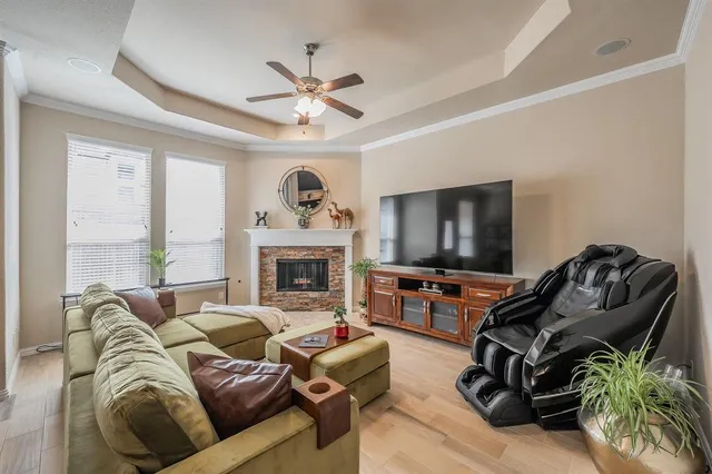 a living room with furniture a flat screen tv and a fireplace