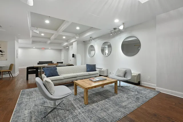 a living room with lots of furniture and kitchen view