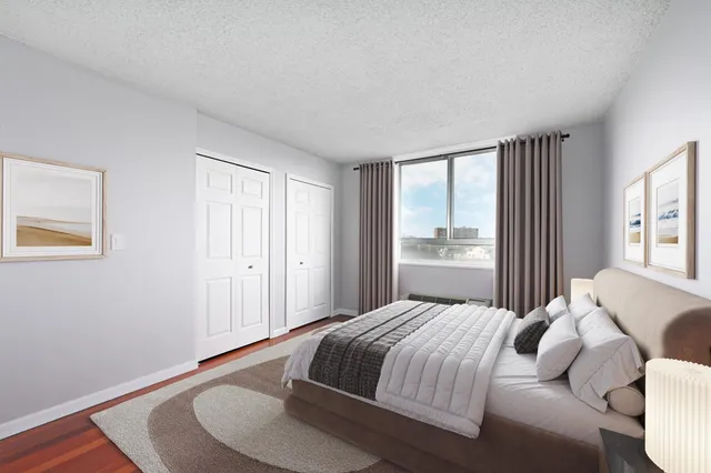 a bedroom with a bed and a window