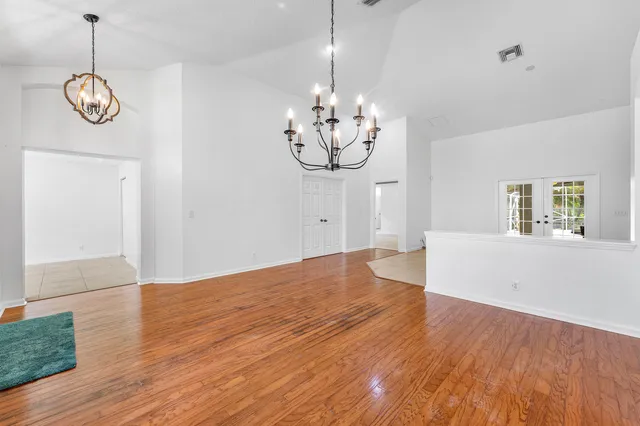 a view of a room with wooden floor and window