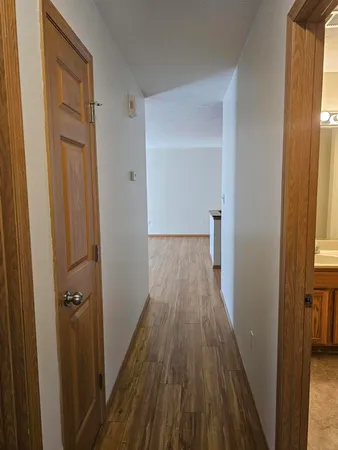 a view of a room with wooden floor