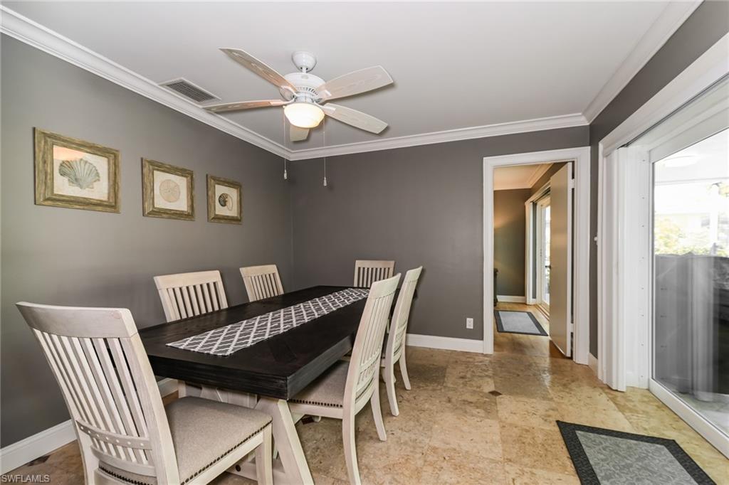 283 Forest Hills Boulevard Naples, FL 34113 - Photo 4 of 11 Dining space with ornamental molding and ceiling fan
