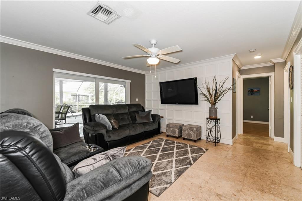 283 Forest Hills Boulevard Naples, FL 34113 - Photo 5 of 11 Living room featuring crown molding and ceiling fan