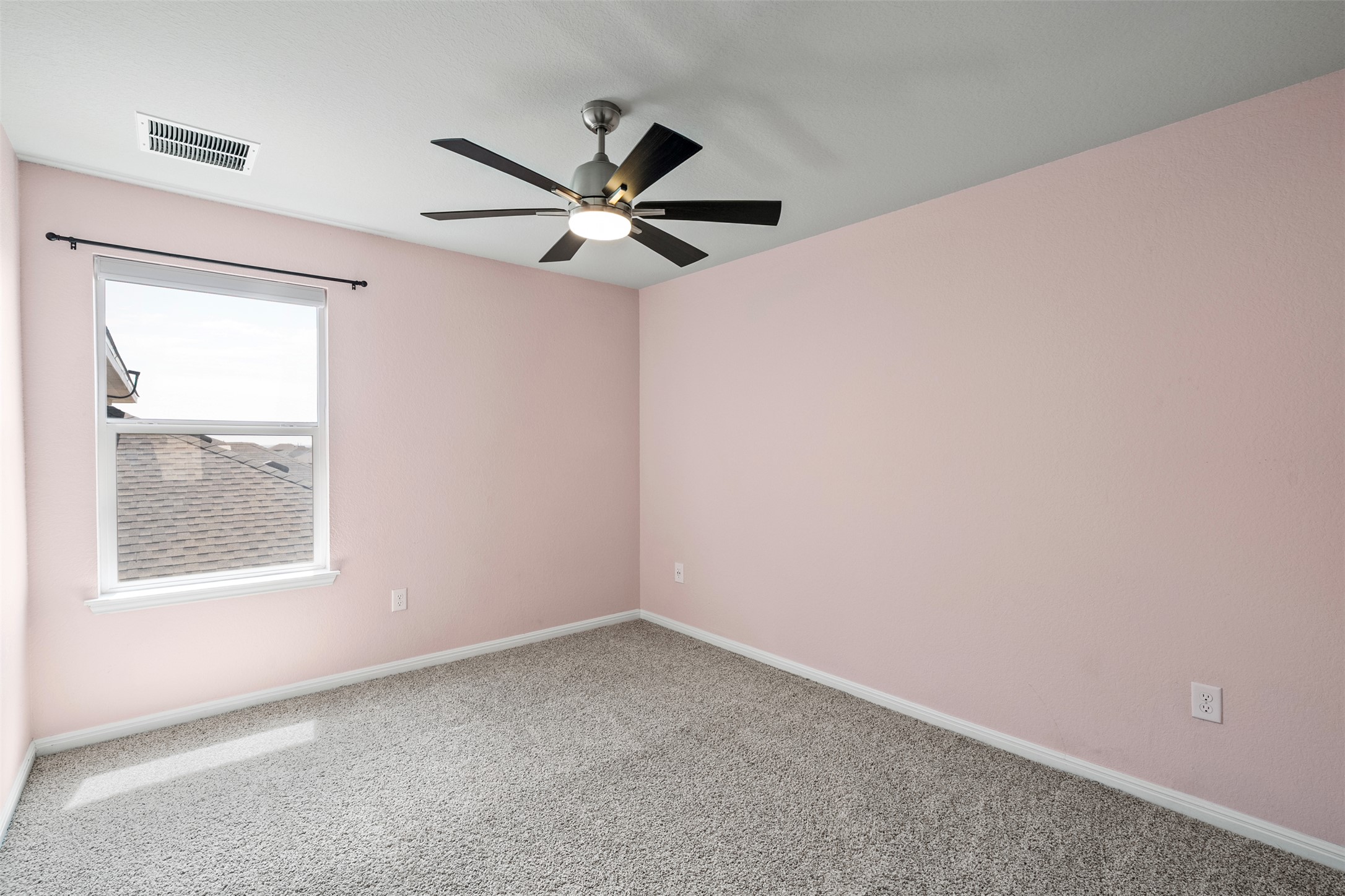 120 Ellinger Road Georgetown, TX 78626 - Photo 20 of 28 Room featuring textured carpet flooring, a ceiling fan with integrated lighting, a single window with a white frame, and light-toned walls
