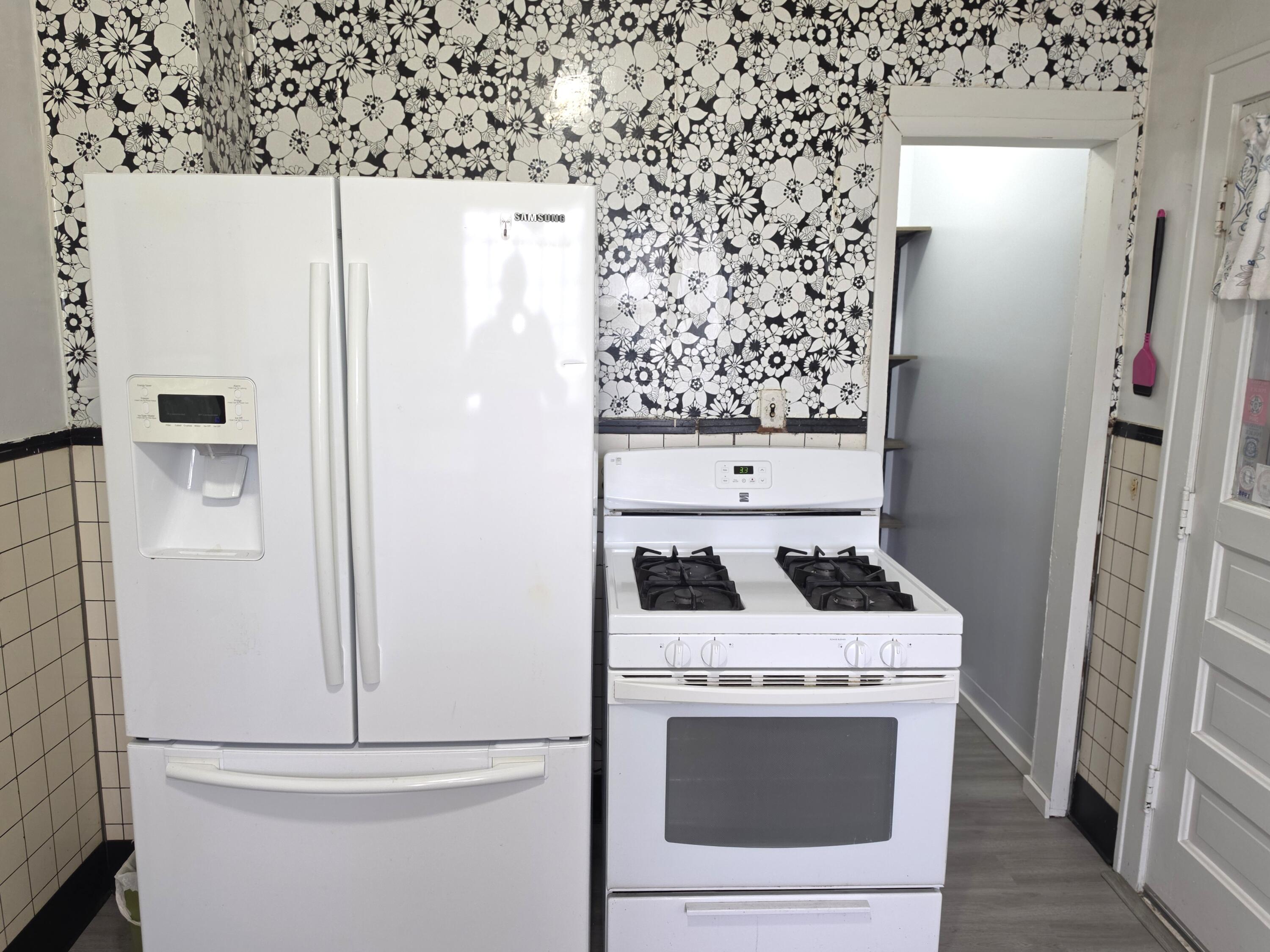 1173 Tyler Street Gary, IN 46407 - Photo 13 of 36 a kitchen with a refrigerator and a stove