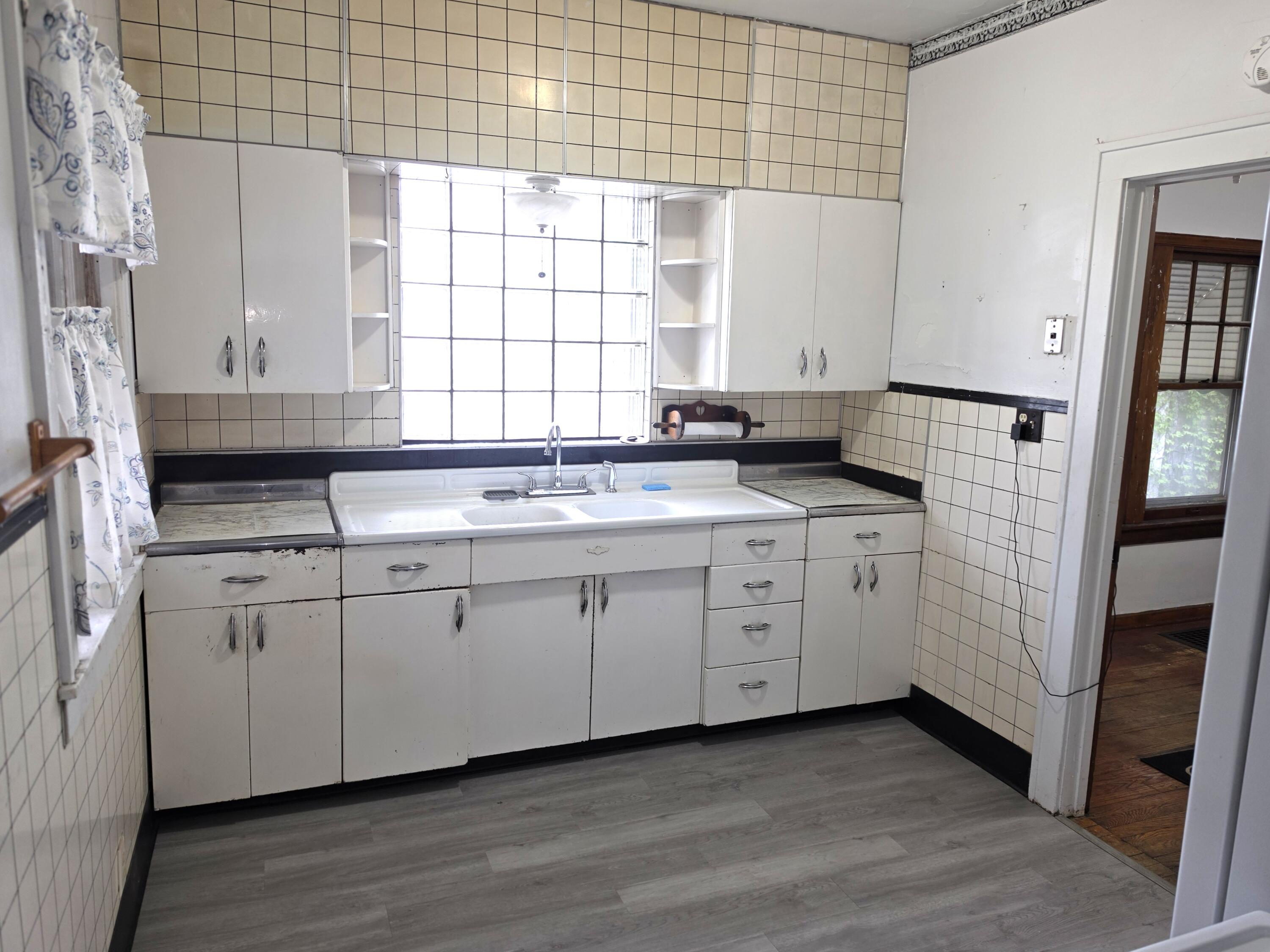 1173 Tyler Street Gary, IN 46407 - Photo 15 of 36 a kitchen with granite countertop white cabinets and white appliances