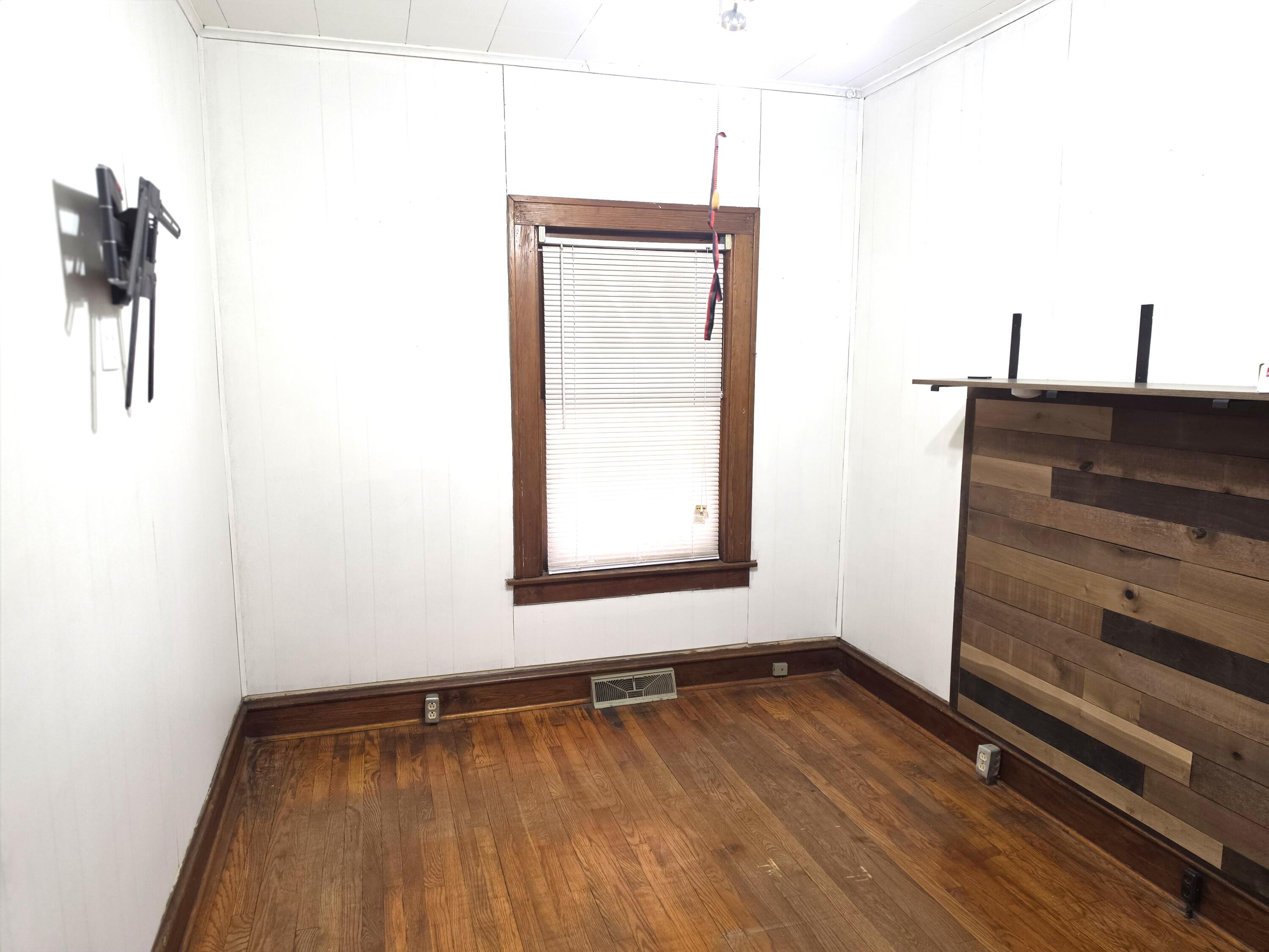 1173 Tyler Street Gary, IN 46407 - Photo 17 of 36 a view of a room with wooden floor and cabinet
