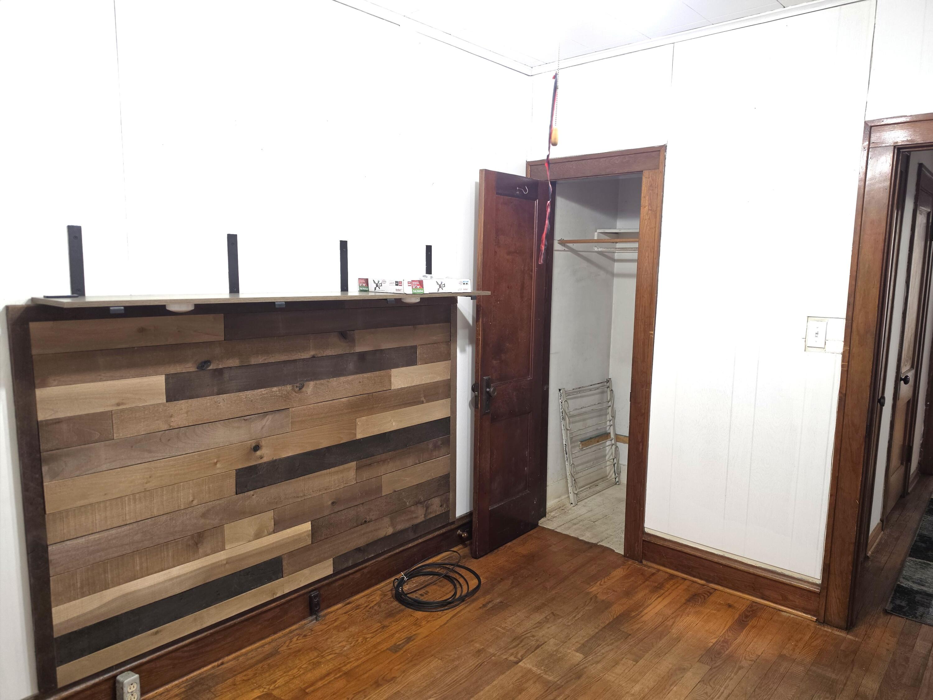 1173 Tyler Street Gary, IN 46407 - Photo 18 of 36 a view of a closet area with wooden floor