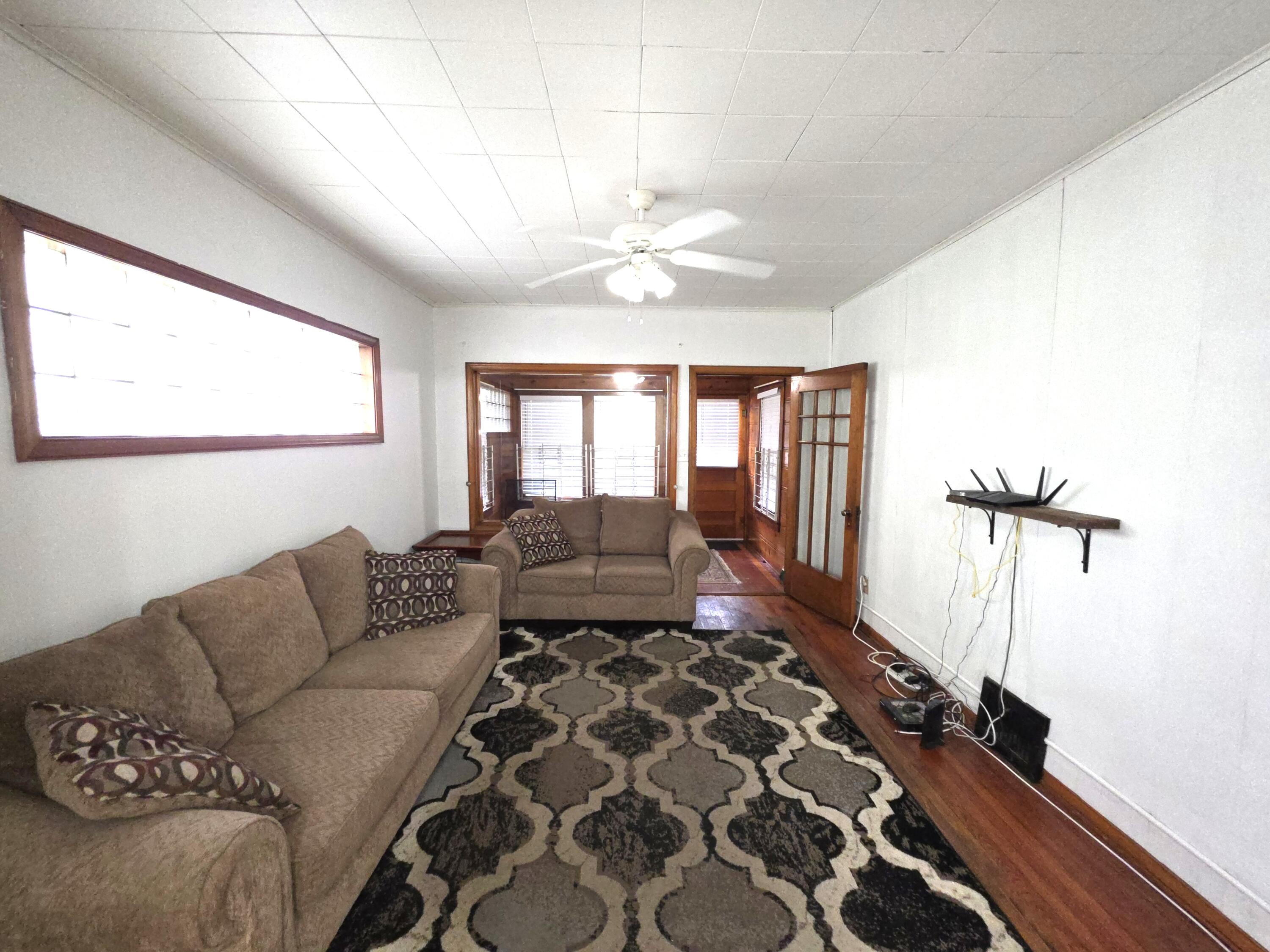 1173 Tyler Street Gary, IN 46407 - Photo 7 of 36 a living room with furniture and a chandelier